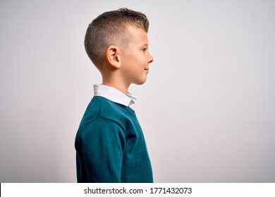 Young Little Caucasian Kid With Blue Eyes Standing Wearing Elegant Clothes Over Isolated Background Looking To Side, Relax Profile Pose With Natural Face With Confident Smile.