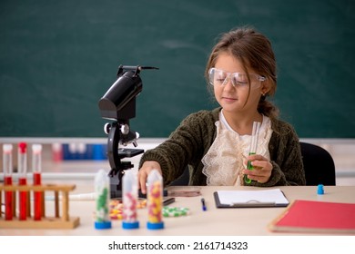 Young little girl chemist in drugs synthesis concept