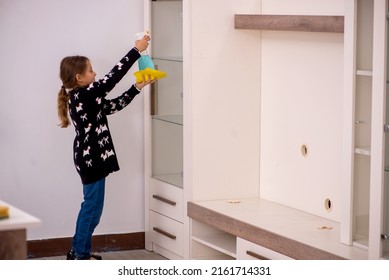 Young little girl doing housework at home