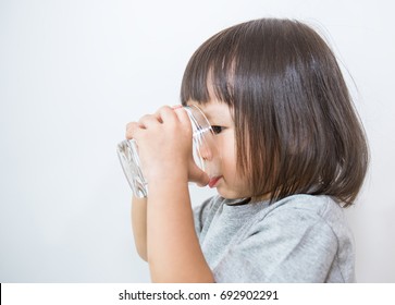 Young little girl drinking water. (water, drink, asian) - Powered by Shutterstock