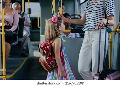 A Young Little Girl And Her Mom Are On The Shuttle Bus Going To The Airport