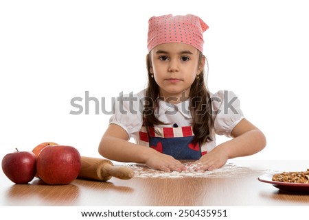 young little girl preparing food with flour at table