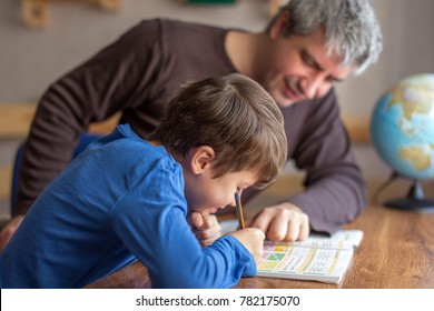 Young little shoolboy solving mathematics homework with father, cooperation in family, parenthood - Powered by Shutterstock