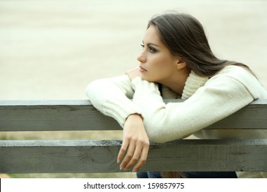 Young Lonely Woman On Bench In Park