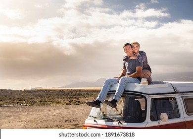 Young Love Couple Sit Down On A Roof Van Enjoy Travel Lifestyle And Holiday Vacation Together - Concept Of Van Life And Free Alternative Trip With Pretty Couple Enjoying Outdoor And Hug