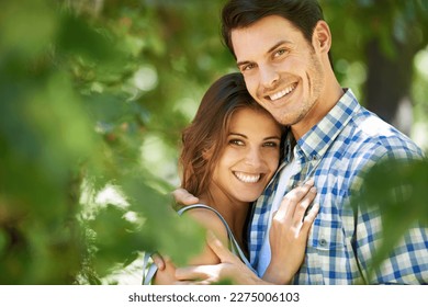 Young and so in love. Portrait of a loving young couple standing in the summer sun. - Powered by Shutterstock