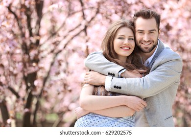 Young Lovely Couple Walking In Spring Park