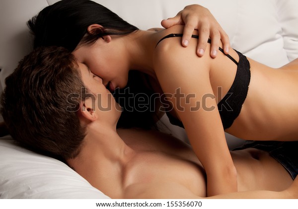 young-lovers-kissing-on-couch-600w-155356070.jpg