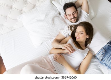 Young loving couple in the bed