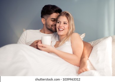 Young loving couple in the bed.Modern lifestyle concept.