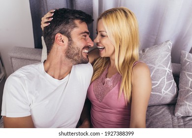 Young loving couple hugging in the bed 