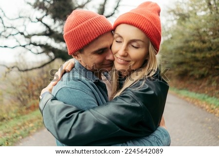 Young loving couple hugging in a natural park in autumn.
