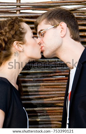 Similar – Young couple kissing in a studio portrait