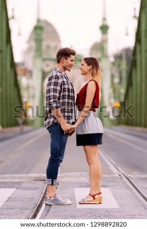 Young loving couple hugging in the street. Young Love Concept.