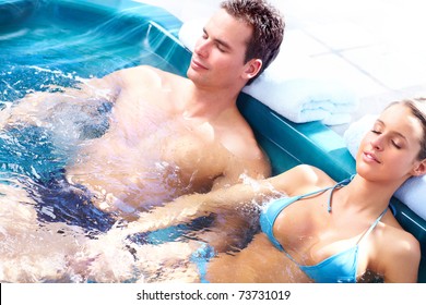 Young loving couple relaxing in a comfortable  jacuzzi.