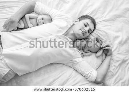 Similar – Relaxed mother and sons playing over the bed