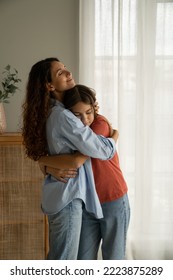 Young loving mother hugging her teenage daughter, mom demonstrating unconditional love for child, mommy cuddling supporting upset teen girl while spending time together at home. Mother-daughter bond  - Shutterstock ID 2223875289
