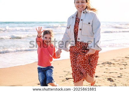 Similar – Little girl running with women on beach