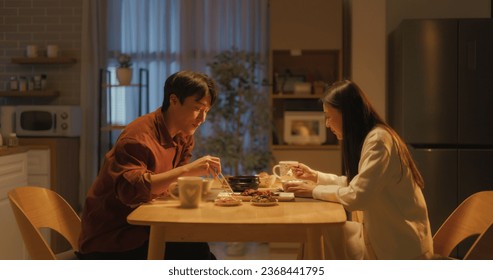 Young Loving South Korean Couple Eating Homemade Tasty Food at Home and Having a Fun Chat. Asian Boyfriend and Girlfriend Enjoying Time Together, Feasting on Cooked Meat, Spicy Vegetable Soup and Rice - Powered by Shutterstock