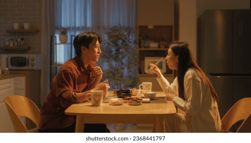 Young Loving South Korean Couple Eating Homemade Tasty Food at Home and Having a Fun Chat. Asian Boyfriend and Girlfriend Enjoying Time Together, Feasting on Cooked Meat, Spicy Vegetable Soup and Rice - Powered by Shutterstock