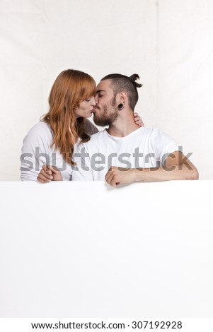 Similar – Young couple kissing in a studio portrait