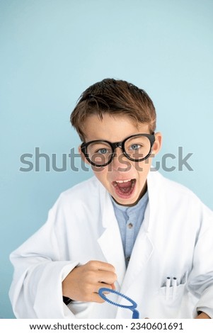 Similar – Happy kid looking at camera through magnifying glass