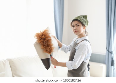 Young Maid Cleaning House With Chicken Feathers