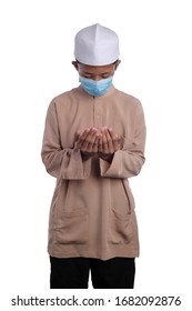 A Young Malay Boy Wearing A Malay Costume And Head Mask Isolated On White Background