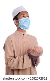 A Young Malay Boy Wearing A Malay Costume And Head Mask Isolated On White Background