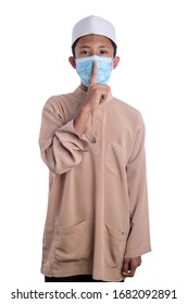 A Young Malay Boy Wearing A Malay Costume And Head Mask Isolated On White Background