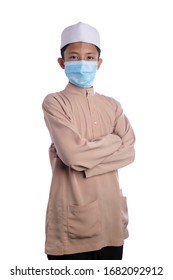 A Young Malay Boy Wearing A Malay Costume And Head Mask Isolated On White Background