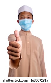 A Young Malay Boy Wearing A Malay Costume And Head Mask Isolated On White Background