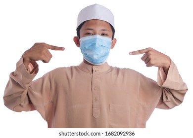 A Young Malay Boy Wearing A Malay Costume And Head Mask Isolated On White Background