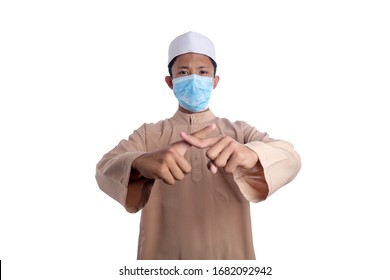 A Young Malay Boy Wearing A Malay Costume And Head Mask Isolated On White Background