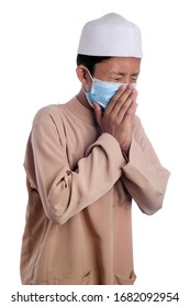 A Young Malay Boy Wearing A Malay Costume And Head Mask Isolated On White Background