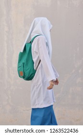 Young Malaysian high school girl in hijab and bag pack. School concept. Cute and beautiful girl in white. - Shutterstock ID 1263522436