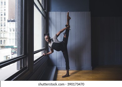 Young male afroamerican dancer practicing in a studio - Powered by Shutterstock