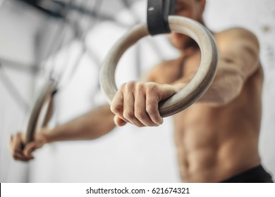 Young Male Athlete With Gymnastic Rings In The Gym. focus on rings - Powered by Shutterstock