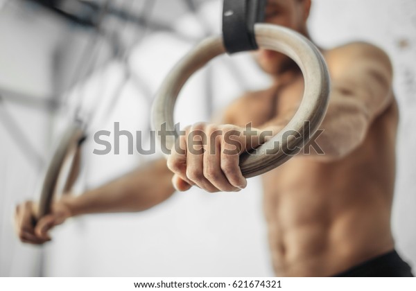 Young Male Athlete With Gymnastic Rings In The Gym.\
focus on rings