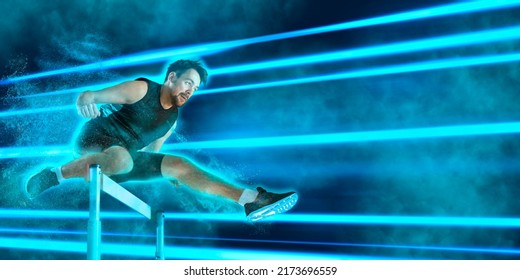 Young male athlete at hurdle race, jumping over the last hurdle. Blue neon background. Sport banner, flyer - Shutterstock ID 2173696559