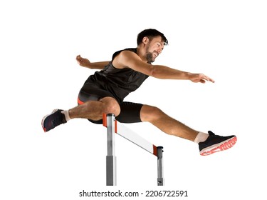 Young male athlete at hurdle race, jumping over the last hurdle. Isolated - Powered by Shutterstock