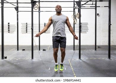 Young male athlete jumping rope in gym. Body care concept. - Powered by Shutterstock