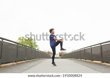 Similar – Happy man and jumping outdoors, warmup before jogging