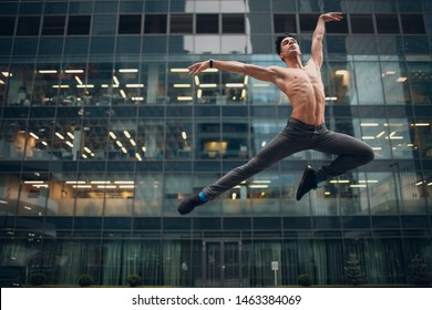 Young male ballet dancer jumping on a building background. Outdoor dance. - Powered by Shutterstock