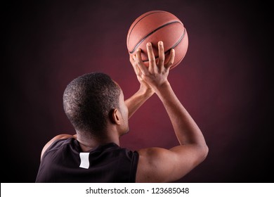 Young male basketball player against black background - Powered by Shutterstock