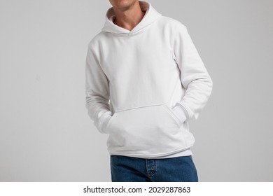 Young male in blank white hoodie front view. Design men  sweatshirt with pocket template and mock-up for branding or print.