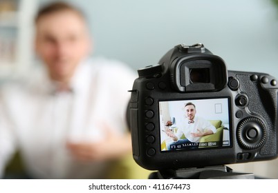Young Male Blogger Recording Video At Home