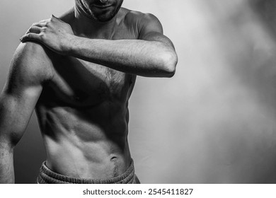 A young male body with well-defined abs and chest. Model with shirtless torso. Concept of body care, male health, fitness, youth, masculinity, health, weightloss, bodybuilding  - Powered by Shutterstock