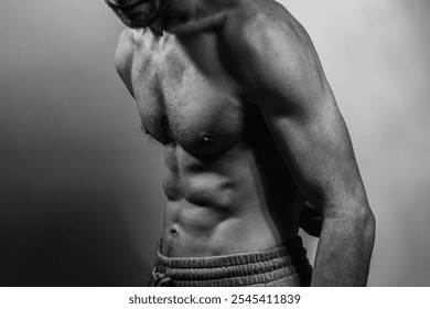 A young male body with well-defined abs and chest. Model with shirtless torso. Concept of body care, male health, fitness, youth, masculinity, health, weightloss, bodybuilding  - Powered by Shutterstock