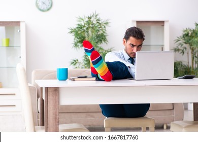 Young male businessman working at home